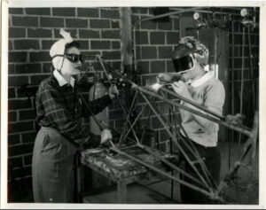 two_cadettes_welding_parts_of_the_tail_of_a_wrecked_plane_1943_28944572512_o