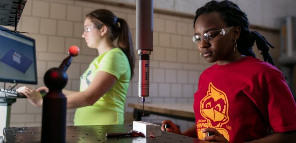 A student operates a piece of equipment