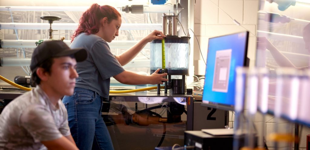 A student takes a measure inside a lab