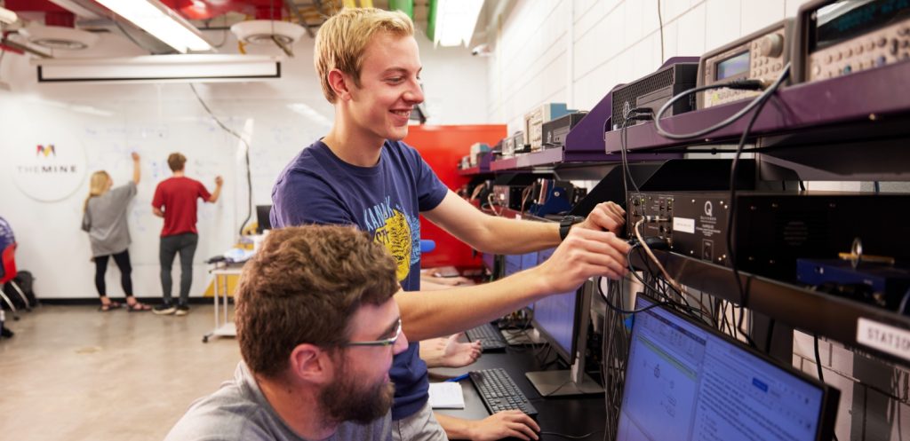 Two students work together inside a lab