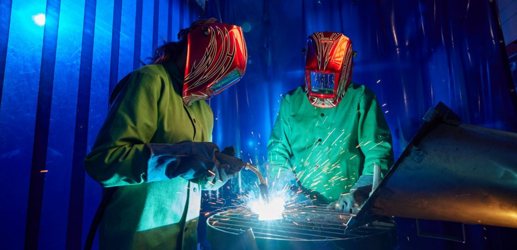 A student practices welding