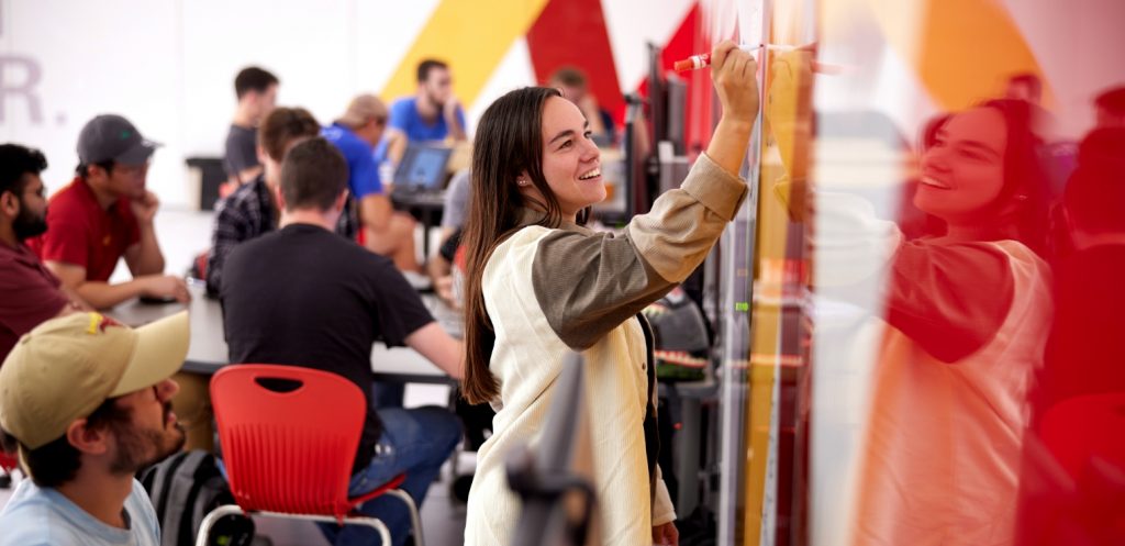 A student draws on a whiteboard