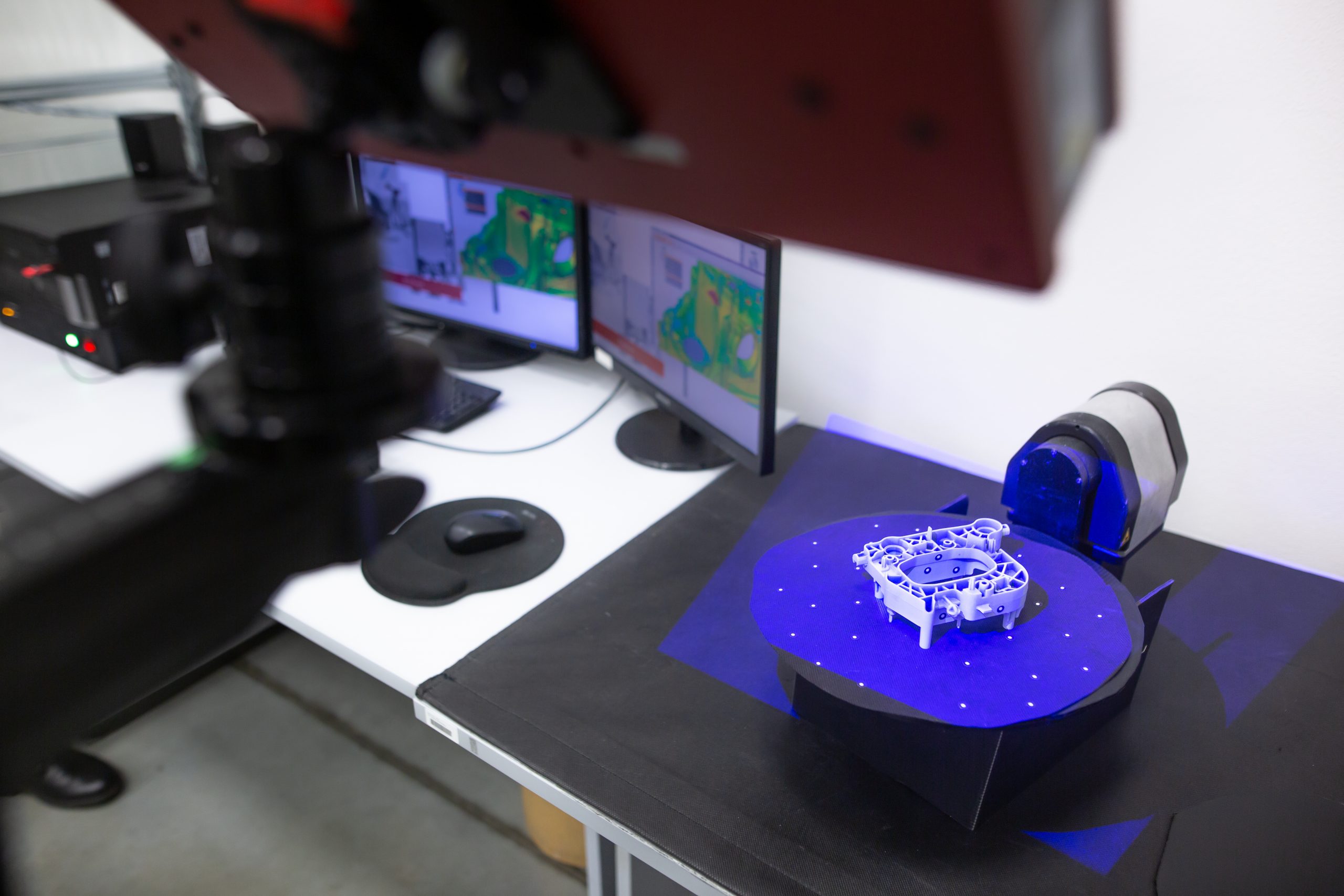 Professional 3D scanner scanning an industrial object plastic molding placed on a turntable