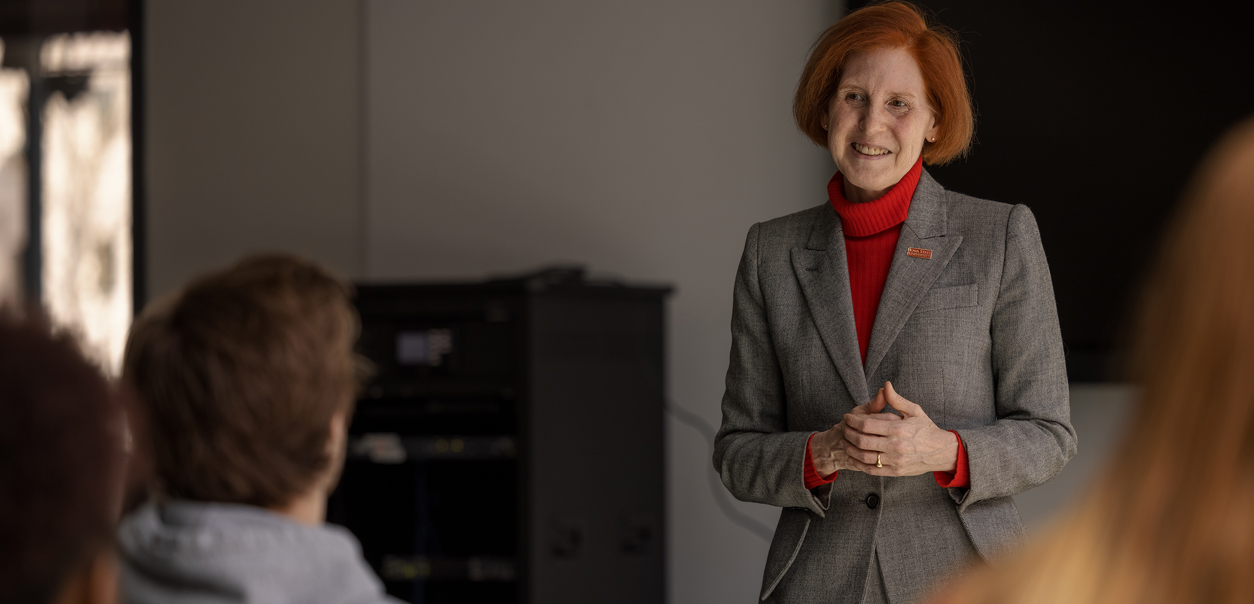 Professor instructing a small group of students at one of the group computer workstations.