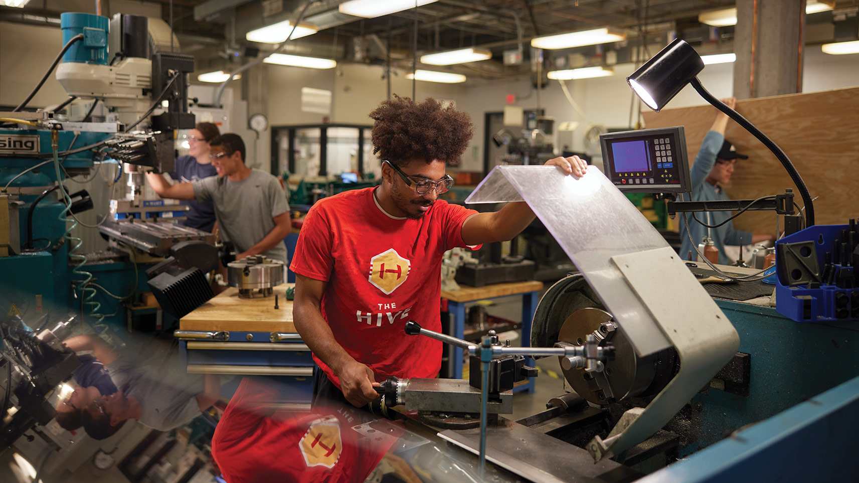 student using metal working equipment in Boyd Lab
