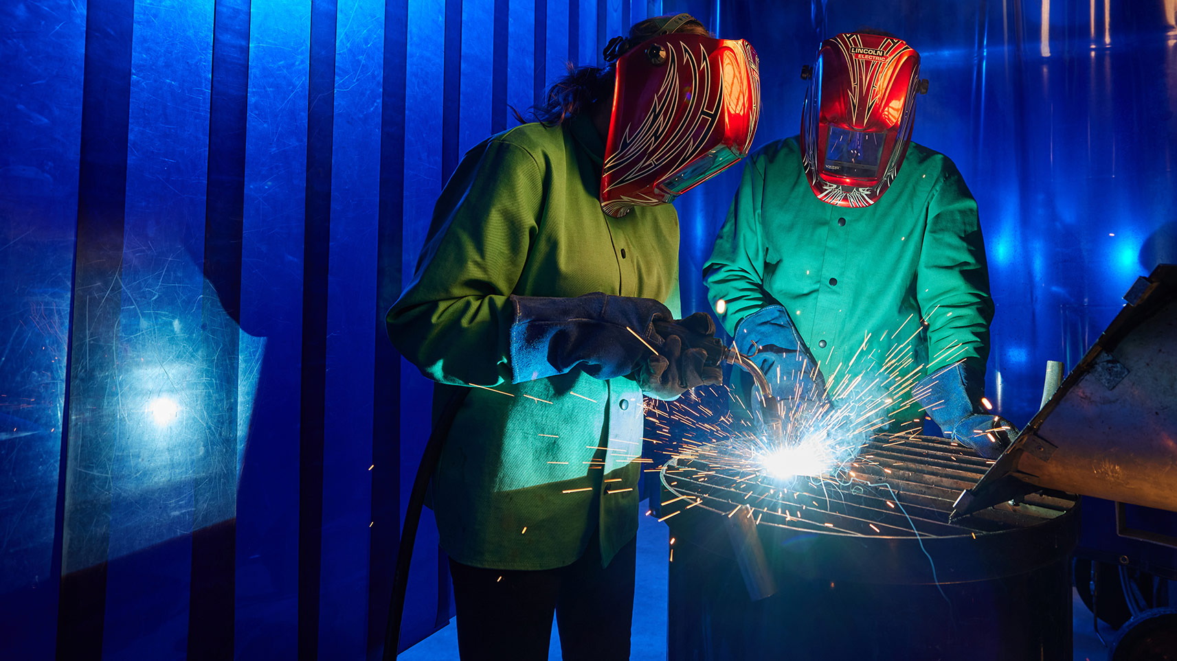 students welding in manufacturing lab