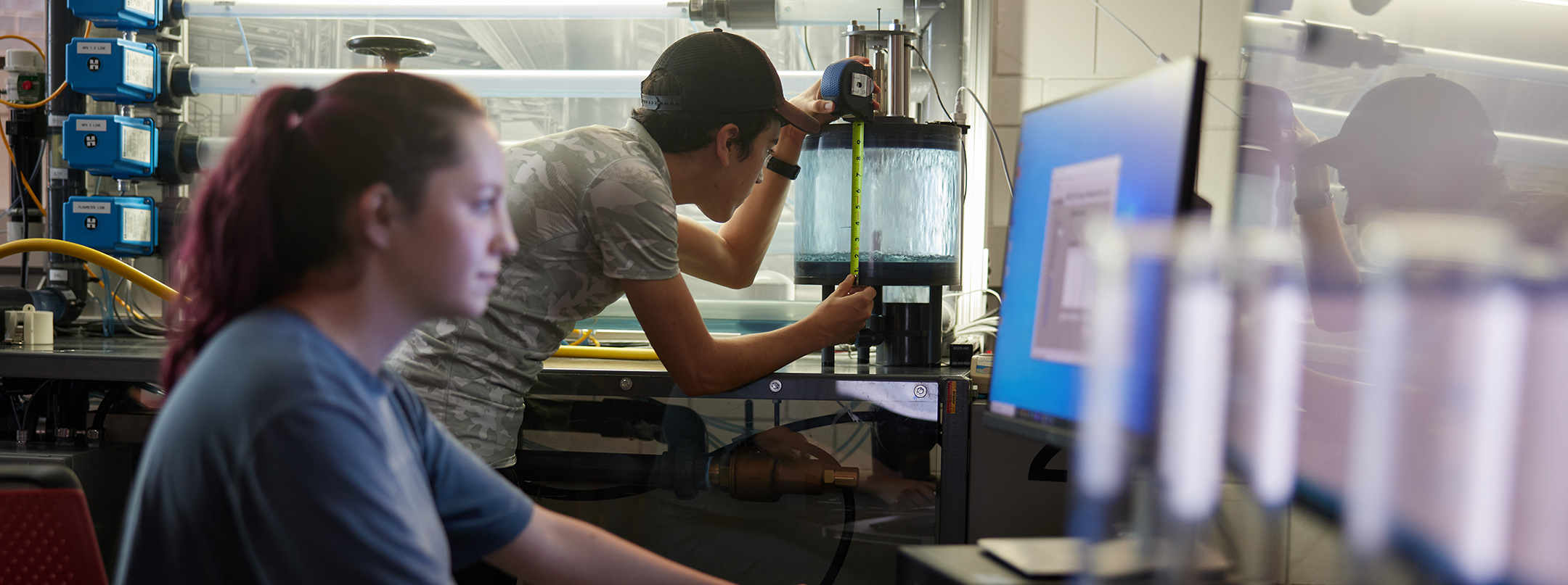 Two students working in a mechanical engineering lab.